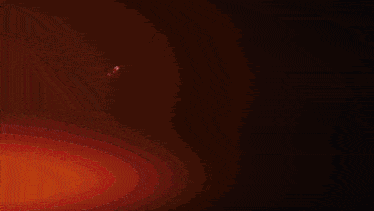 a person is standing in a dark room with a red light behind them