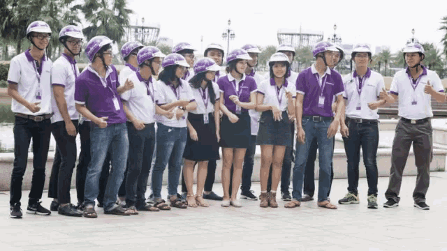 a group of people wearing purple and white shirts and purple helmets