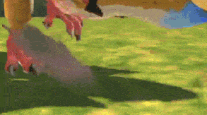 a close up of a dinosaur 's claws on a lush green field