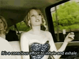 a woman in a strapless dress is sitting in a car and says it 's a conscious effort to exhale