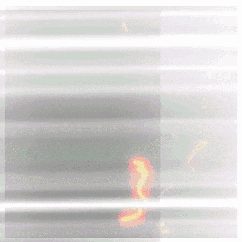 a blurred image of a green bottle with a red flame on it
