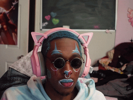 a man wearing headphones and sunglasses has a cat ear shaped headband