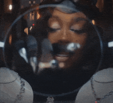 a woman 's face is reflected in a glass ball