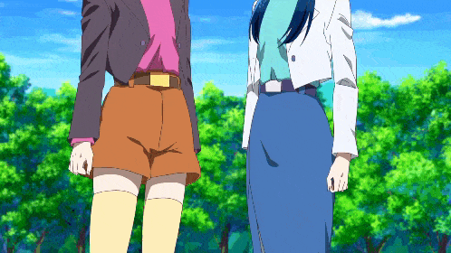 two anime characters standing next to each other in front of trees