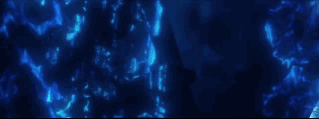 a woman in a blue dress is standing in the water