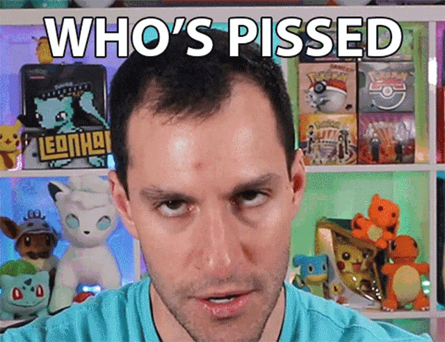 a man is standing in front of a shelf with pokemon toys and the words who 's pissed on his face
