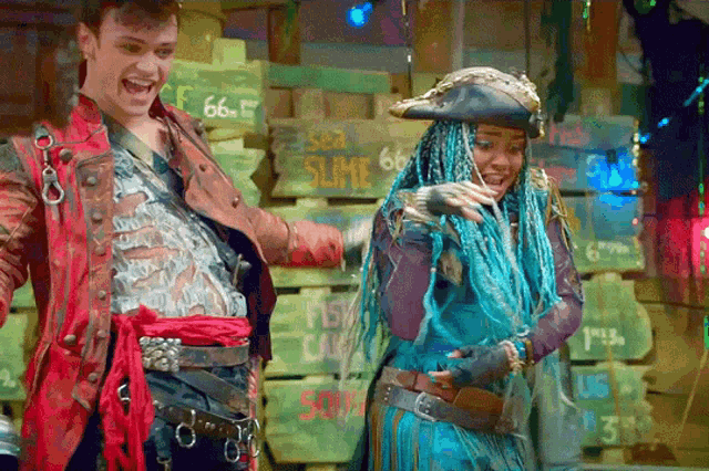 a man and a woman are standing in front of a sign that says sea slime on it