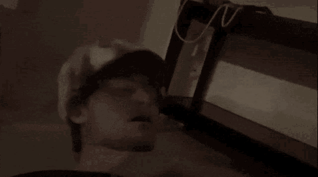 a man in a hat says " i 'm dead " in a dark room