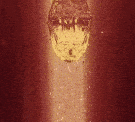 a glowing object is coming out of a hole in the ground .