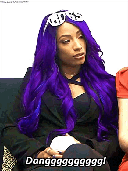 a woman with purple hair is wearing a headband with the word boss on it