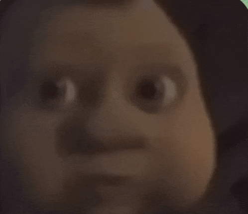 a close up of a baby 's face with a blurred background .