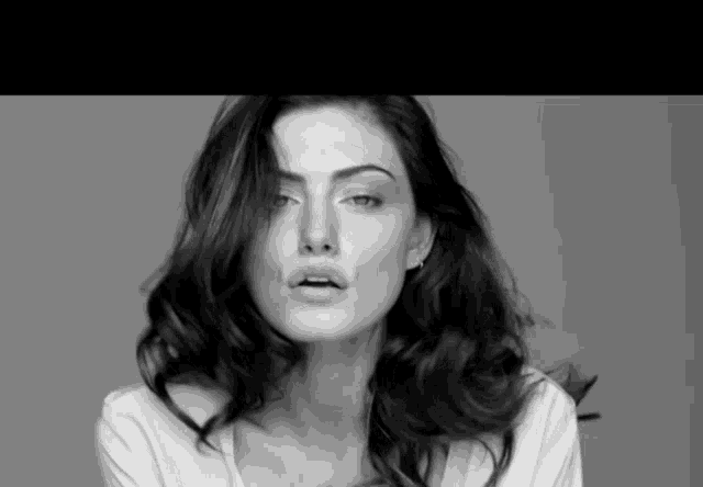 a black and white photo of a woman 's face with her mouth open