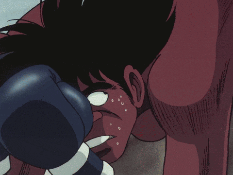 a cartoon of a man wearing boxing gloves is laying on the ground