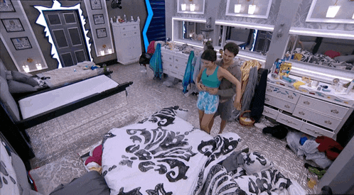 a man and woman are hugging in a bedroom