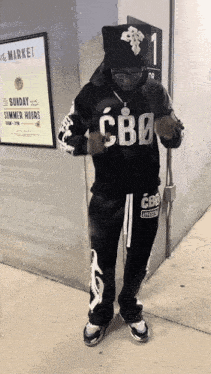 a man wearing a hoodie that says cbd on it