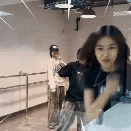 a group of young women are dancing in a room .