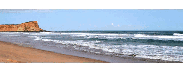 a large body of water with waves crashing on the beach