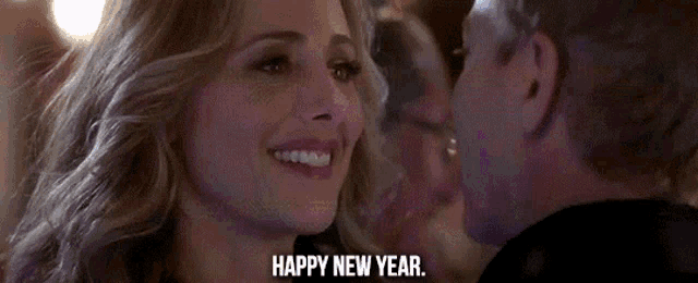 a woman with purple hair says happy new year in front of a man
