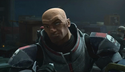 a close up of a man in armor holding a gun .