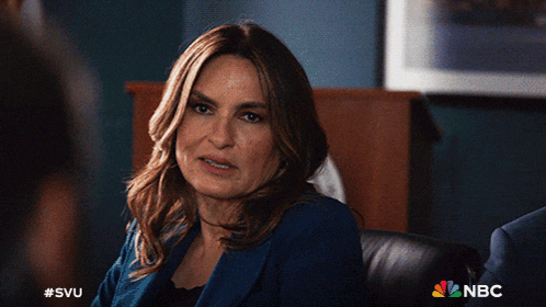 a woman in a blue jacket sits in a chair with the nbc logo on the bottom right