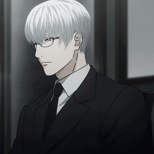 a man with white hair wearing glasses and a suit