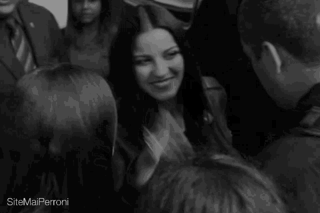 a black and white photo of a group of people with the words sitemailperroni on the bottom right