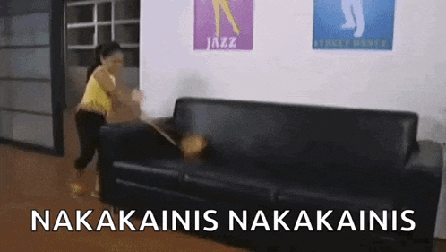 a woman is standing next to a black couch with a sign that says jazz on it