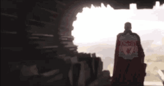 a man in a red cape that says liverpool on it