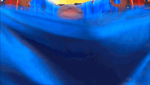 a man with glasses is swimming in a waterfall