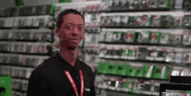 a man is standing in front of a video game store .
