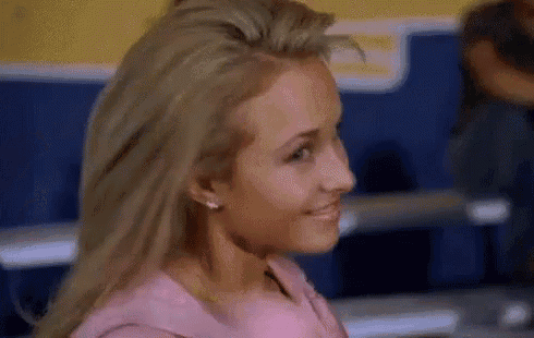 a close up of a woman 's face in a pink dress .