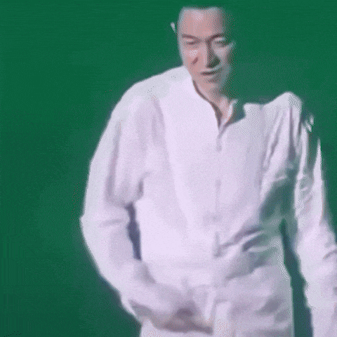 a man in a white shirt is dancing on stage .