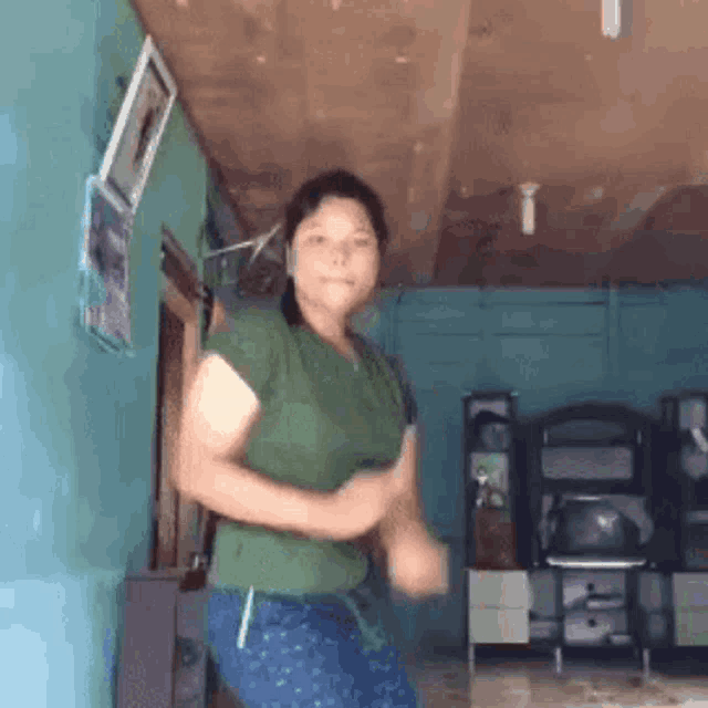 a woman is dancing in a living room .