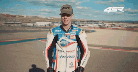 a man wearing a racing suit with the word movisio on it