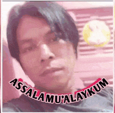 a man is taking a selfie with the words assalamu alaykum written around his neck