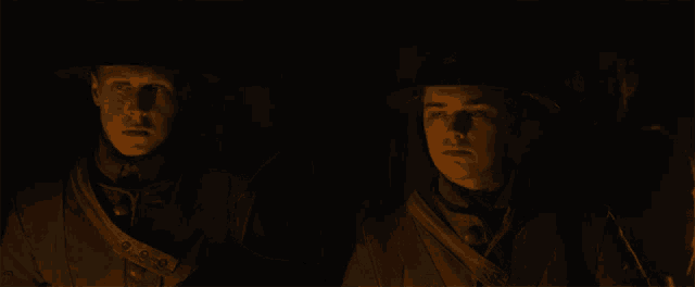 a group of soldiers are standing in the dark looking at something