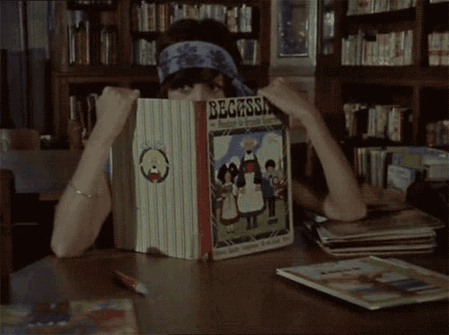 a woman is reading a book titled begassini