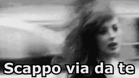 a black and white photo of a woman with the words scappo via da te written in white letters .