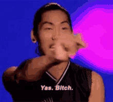 a man in a basketball jersey is pointing at the camera and says yas bitch .
