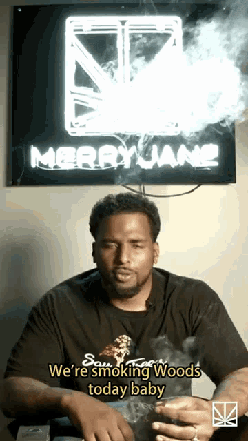 a man is smoking a cigarette in front of a sign that says merryjane