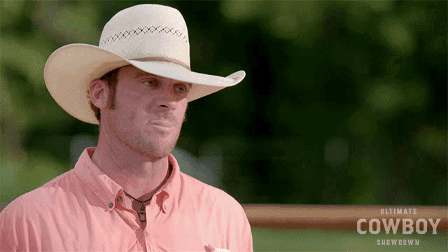 a man wearing an ultimate cowboy showdown hat and shirt