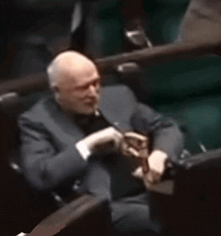 a man in a suit and tie is sitting in a chair