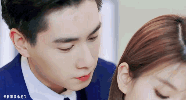 a man in a suit and tie is looking at a woman