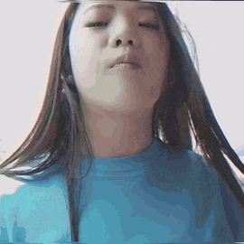 a woman with long hair wearing a blue shirt