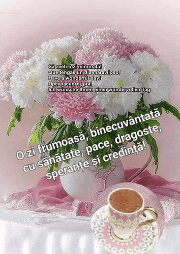 a cup of coffee sits on a saucer next to a vase of pink flowers