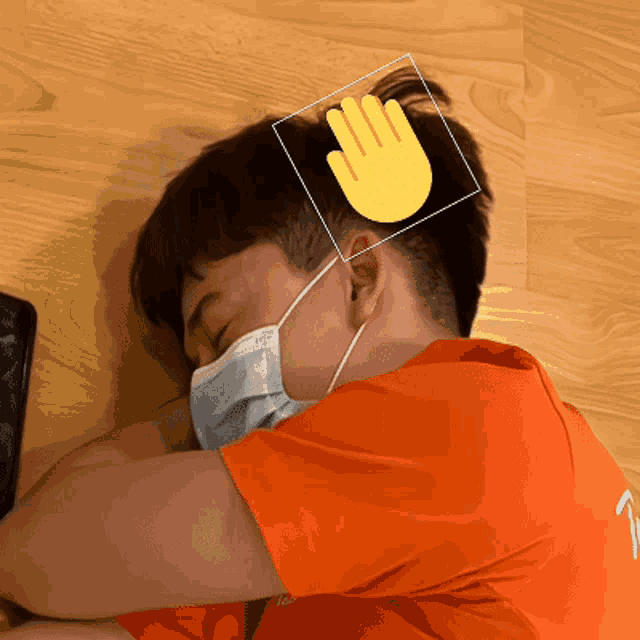 a person wearing a face mask has a hand drawn over their head