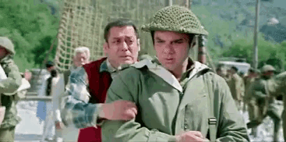 a man in a helmet is holding another man 's arm in a crowd of people .