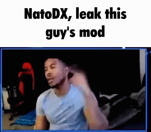 a man in a blue shirt is making a funny face in front of a computer screen .