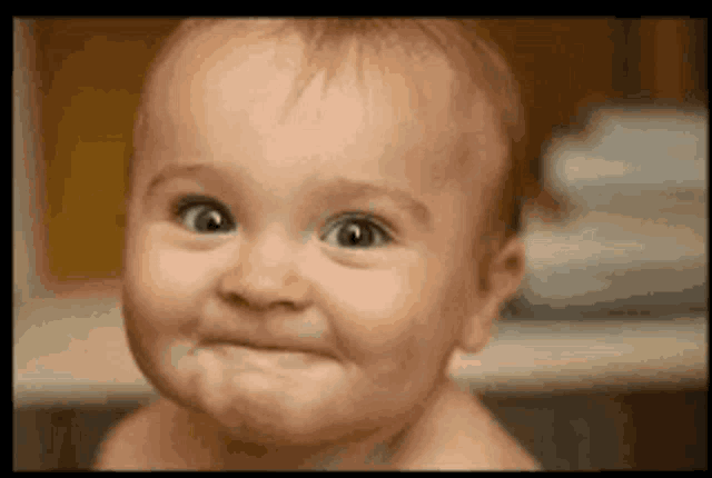 a baby making a funny face with his eyes wide open
