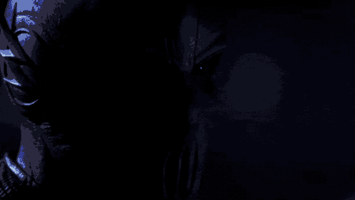a close up of a person 's face in the dark with a blue light coming out of their eyes .